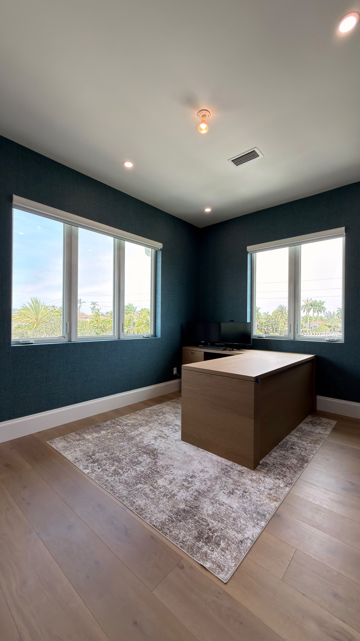 Home office with deep blue textured wallcovering in a Fort Lauderdale home by Salt Wallcovering