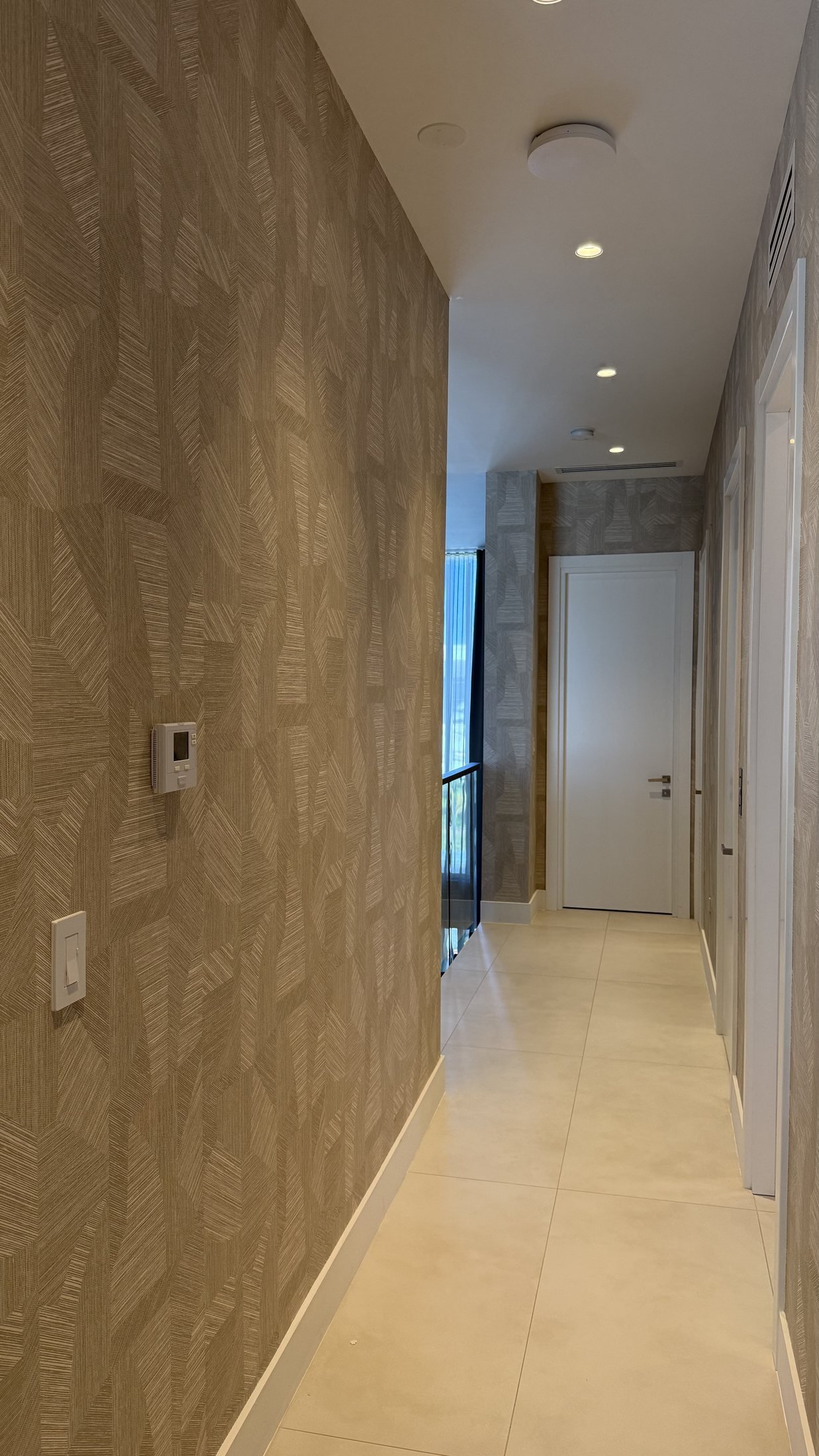 Hallway with wallcovering in a Miami residence by Salt Wallcovering