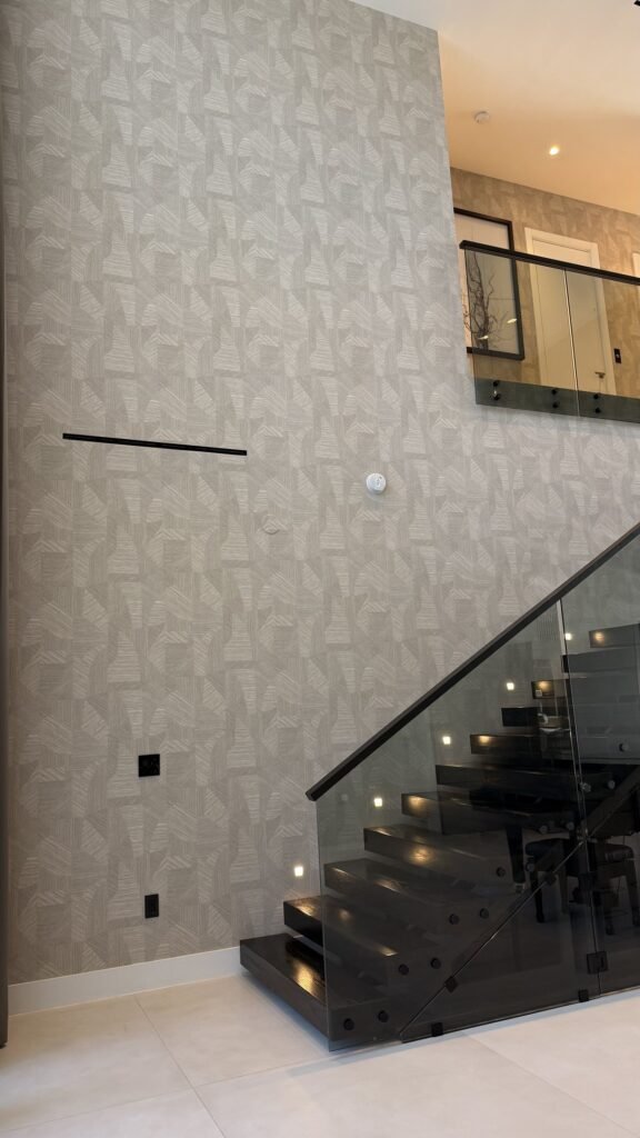 Textured wallcovering detail on a staircase wall in a Miami residence by Salt Wallcovering
