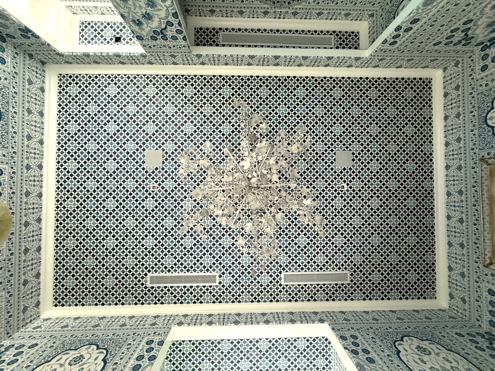 Patterned ceiling wallcovering with matching floral walls in a Palm Beach residence by Salt Wallcovering