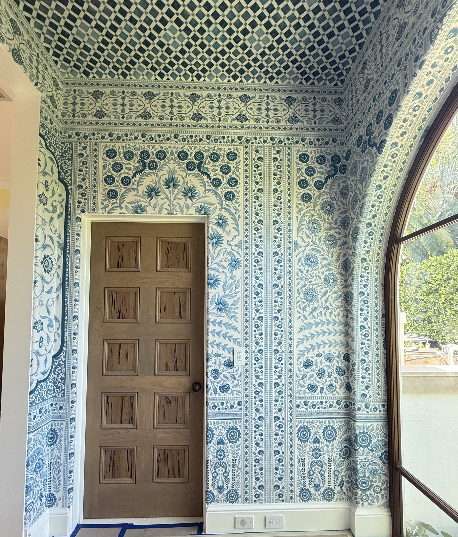 Blue and white hand-drawn wallpaper with a lattice ceiling in a Palm Beach residence by Salt Wallcovering