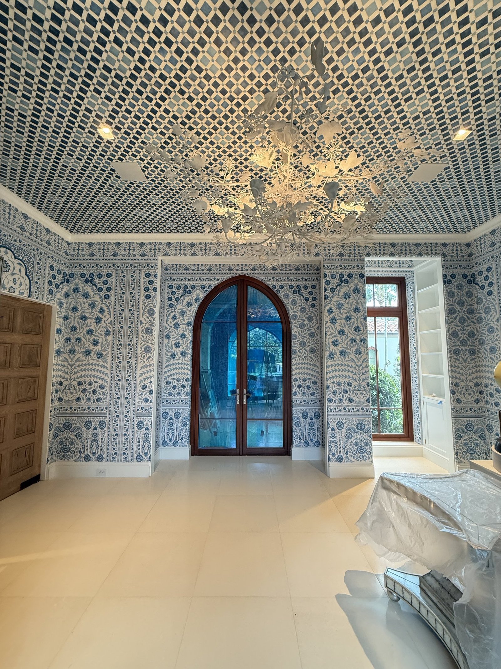 Blue and white hand-drawn wallpaper with a lattice ceiling in a Palm Beach residence by Salt Wallcovering