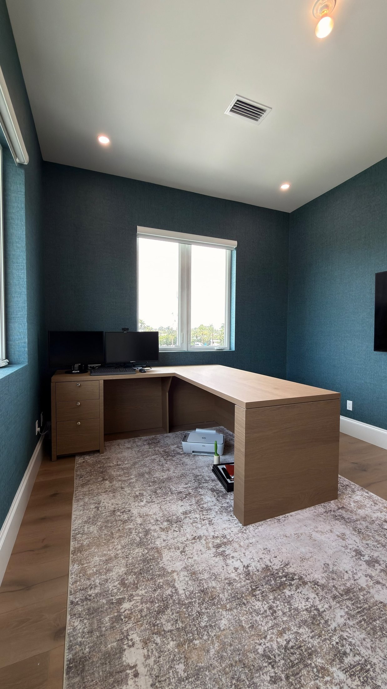 Home office with deep blue textured wallcovering in a Fort Lauderdale residence by Salt Wallcovering