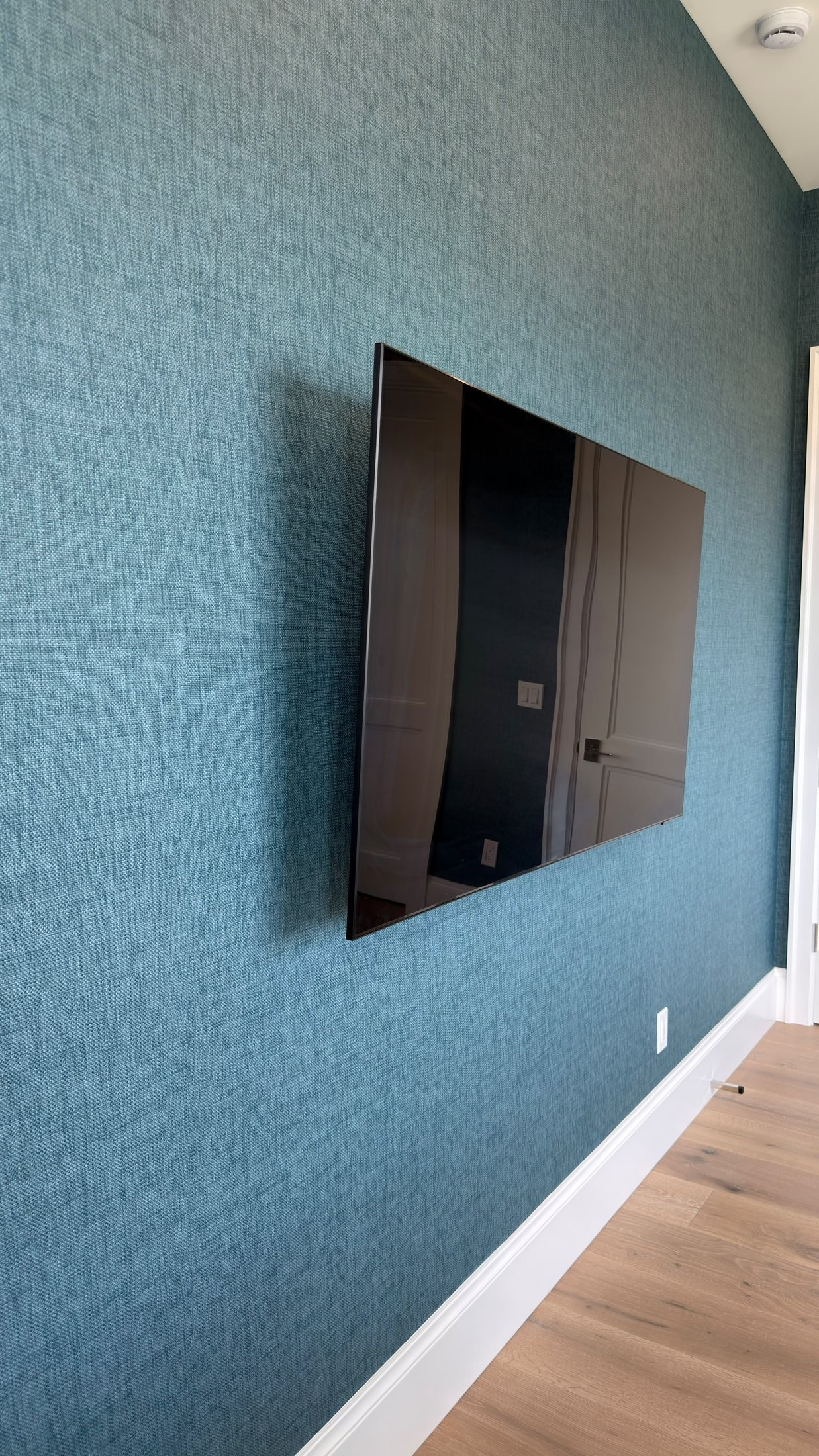Home office with deep blue textured wallcovering in a Fort Lauderdale residence by Salt Wallcovering