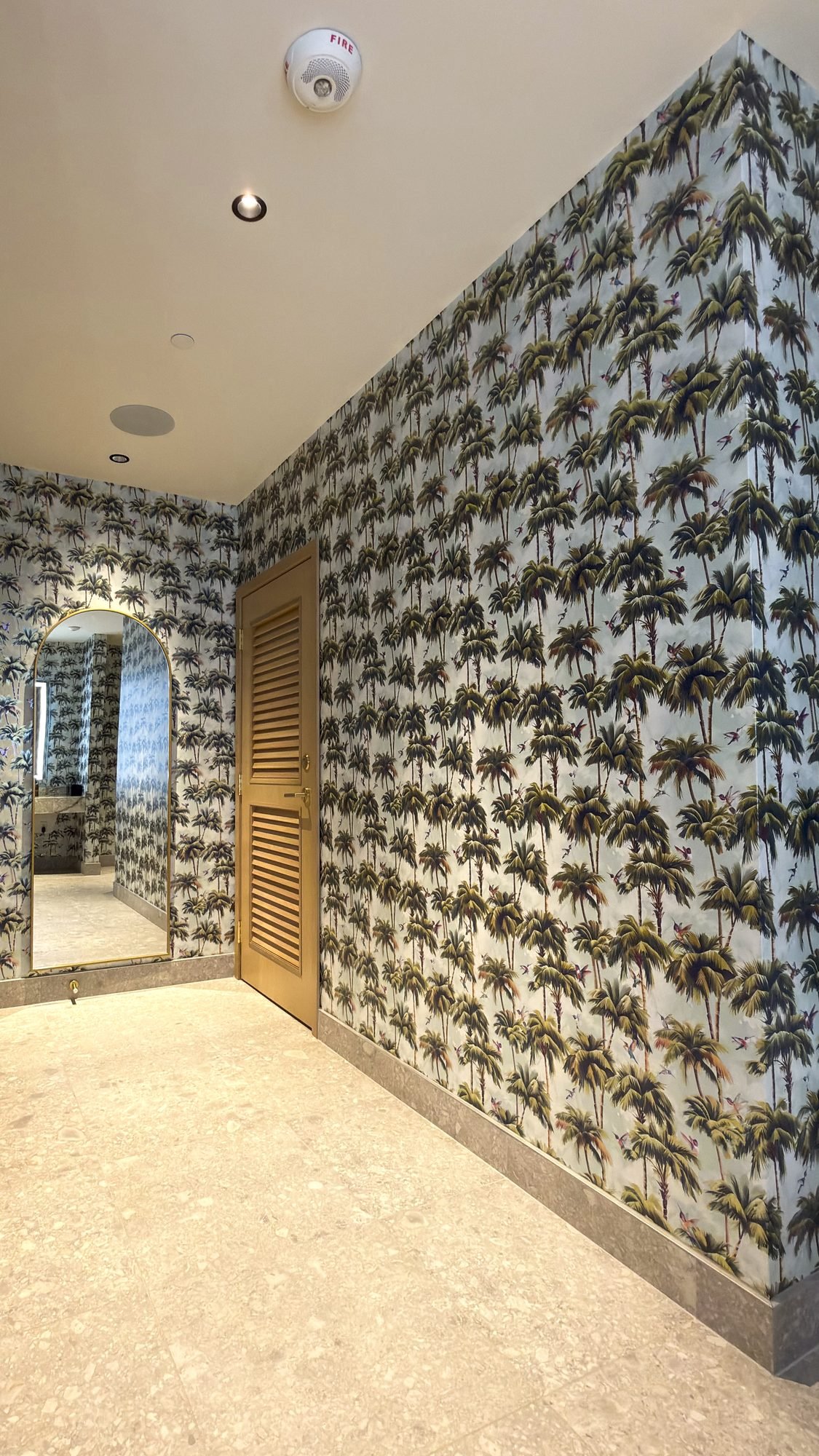 Palm print wallpaper installation in a restaurant in West Palm Beach by Salt Wallcovering