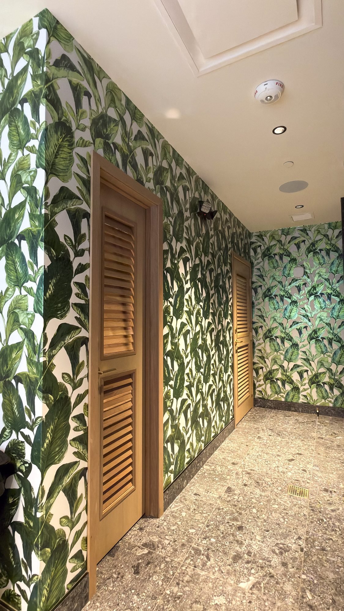 Botanical wallpaper installation in a restaurant restroom in West Palm Beach by Salt Wallcovering